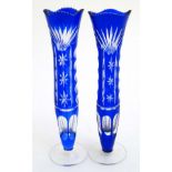A pair of blue overlay glass vases on clear pedestal bases 9 1/2" high CONDITION:
