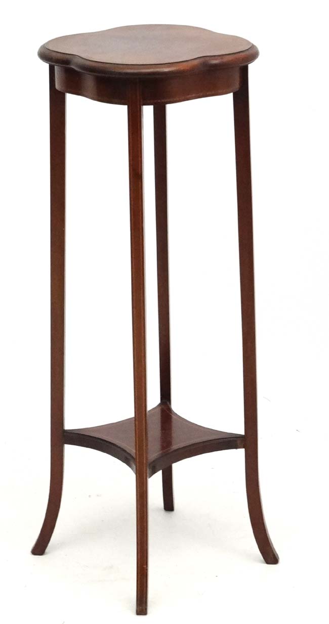 An Edwardian 2 tier plant stand of quatre form with splayed legs 14 1/4" diameter x 37" high