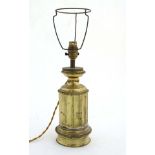 Light : An early 20thC gilt brass table lamp in the form of a lower part of a fluted circular