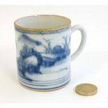 A small Oriental Blue and white coffee can decorated with an Oriental landscape and having gilt rim.
