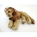 A c1950s '' Steiff '' Leo the Lion , formed as a recumbent lion with golden fur ,