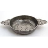 A French 18th/19thC pewter porringer having double decorative handles. 10'' wide.