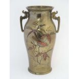 An oriental cast bronze baluster shaped vase having silver and copper inlay with gilded decoration