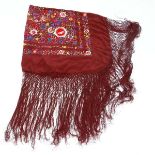 A late 20thC large wine red silk shawl with machine embroidered floral decoration in multi colours
