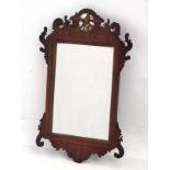 A Georgian mahogany wall mirror with gilt Ho Ho like bird decoration to top .