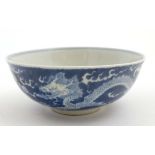 A Chinese blue and white dragon bowl decorated with 5 clawed dragons and flaming pearls of wisdom