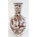 A Chinese iron red and white pottery bottle vase with flared rim ,