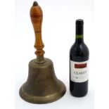 A large handbell with turned fruit wood handle,