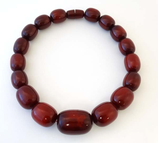 A Vintage bead necklace of graduated cherry coloured beads.