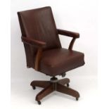 A 1940's adjustable height swivel and tilt open arm office chair.