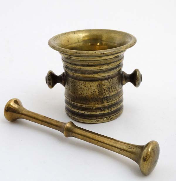 A 19thC brass Apothecary's pestle and mortar. The Mortar 4'' high.