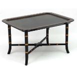 A Regency style faux bamboo papier-mache coffee table with ebonised and gilt,