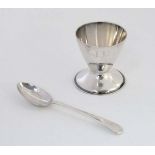 A silver egg cup of conical form hallmarked London 1971 maker Roberts & Belk together with an