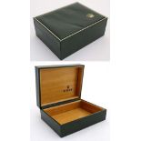 A gold tooled green leather box for a Rolex wrist watch. 5" wide x 2" high x 4" deep.