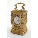 Miniature Carriage clock : an ornate ormolou cased 21 st C miniature timepiece,