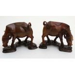 A pair of Chinese wooden water buffaloes on stands 6 1/2" high CONDITION: Please