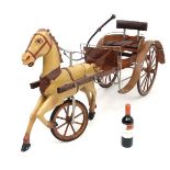 A rare early / mid 20thC wooden childs toy pedal cart formed as a painted dun trotting pony /