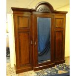 A 19thC mahogany breakfront triple wardrobe with central section with drawers and linen sides 94"