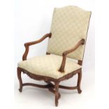 A c.1900 carved oak French open armchair.