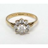 A 9ct gold ring set with white stones in a daisy setting CONDITION: Please Note -