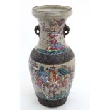 A large Chinese crackle glazed two handled vase decorated with figures and horses in a mountainous