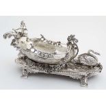 A large 21stC silver plated table centrepiece formed as a cherub in a boat with floral garlands and