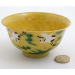 A Chinese yellow ground porcelain tea bowl,