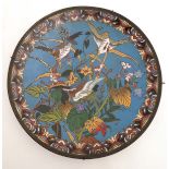 An Oriental Cloisonne charger decorated with images of geese amongst foliage and flowers.