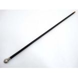 A white metal topped ebonised walking cane with horn ferrule 36" long CONDITION: