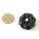 A 9ct gold brooch set with carved jade flower head decoration with pearl to centre.