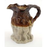 A late 19thC Brampton brown style salt glazed jug decorated in relief in a classical style with