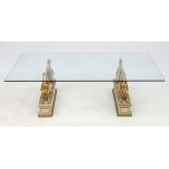 Mid century / Hollywood Regency : a plate glass coffee table with two pairs of winged Sphinx