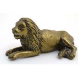 A 19thC cast brass figure of a lion couchant.