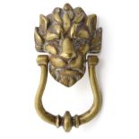 An early - mid 20thC cast brass door knocker in the form of a lions head. approx 4 1/2" wide.