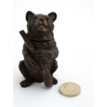 A late 19thC cold painted bronze inkwell formed as a Black Forest bear with hinged lid holding a