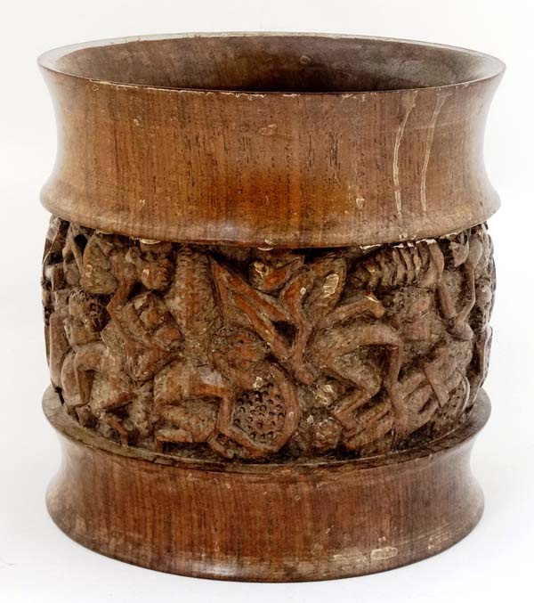 An African turned wooden pot with banded detail depicting figures at work etc.