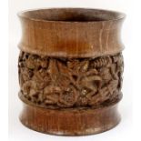 An African turned wooden pot with banded detail depicting figures at work etc.