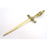 A late 19thC cast brass paper knife in the form of a dagger with cast knight formed handle 10" long