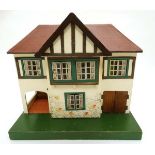 A Triang wooden 1950s dolls house, number 61 , having remains of original Triang sticker to back,