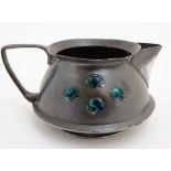 Art Nouveau : A Tudric ( Liberty ) enamel decorated pewter short jug. Number 03030, marked under.