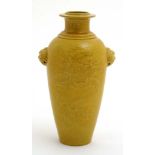 A Chinese yellow glazed twin handled dragon vase,