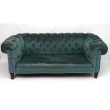 A c.1900 button back Chesterfield sofa with walnut legs.