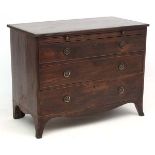 A Georgian mahogany cross banded bachelor chest with three graduated drawers and splayed legs.