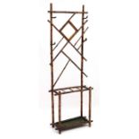 A late 19thC bamboo hall stand with bevelled edge central mirror, coat hooks and stick stand,