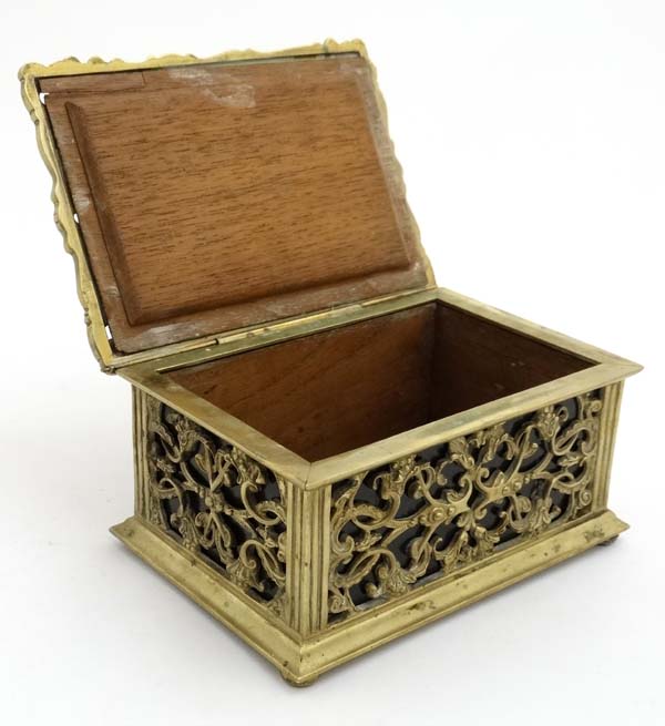 A late 19thC brass and cedar lined humidor with image to top of putti amongst Rococo brass ware 8" - Image 6 of 7