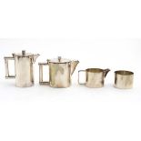An Art Deco 4-piece EPNS tea set comprising teapot hot water pot, milk jug and sugar bowl.