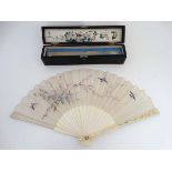 A Victorian 21 stick ivory fan with relief sillkwork decorated with birds amongst prunus etc,