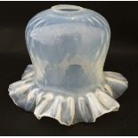 A c.1900 vaseline glass lamp shade moulded with fine netted design with frilled rim.