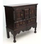 A 17thC / 18thC carved and inlaid oak cabinet on stand 50" wide x 21 1/4" deep 15 1/2" high