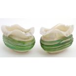 A pair of Loetz style boat shaped vases with green trailed glass detail over iridescent opaline